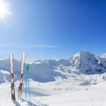 Skiing equipments on ski slope in italian Alps